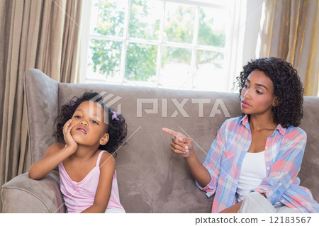 Pretty mother scolding her daughter on the couch 12183567