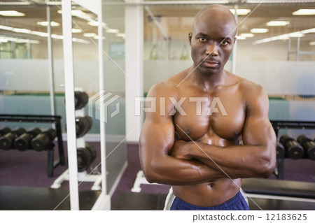 Serious shirtless muscular man in gym Serious shirtless muscular man in gym 12183625
