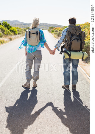 Attractive couple standing on the road holding hands Attractive couple standing on the road holding hands 12184094