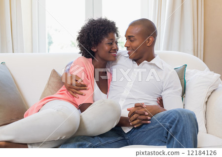 Happy couple relaxing on the couch 12184126
