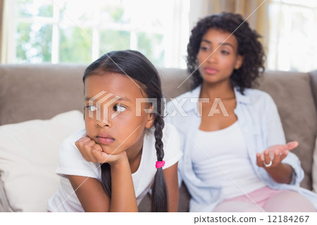 Pretty mother sitting on couch after an argument with daughter 12184267
