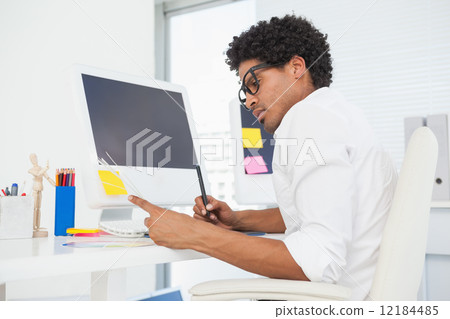 Hipster designer working at his desk Hipster designer working at his desk 12184485