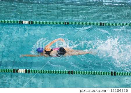 Fit swimmer training by herself 12184536