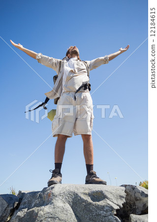 Handsome hiker standing at the summit 12184615