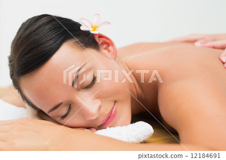 Peaceful brunette enjoying a back massage Peaceful brunette enjoying a back massage 12184691