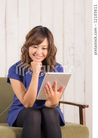 Woman sitting on the couch Woman sitting on the couch 12185611