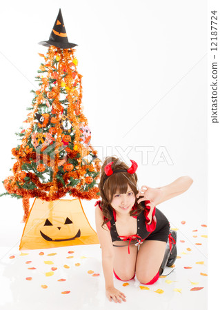 一個可愛的小惡魔服裝的一個女孩在萬聖夜 一個可愛的小惡魔服裝的一個女孩在萬聖夜 12187724