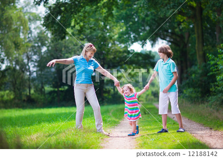 Family hiking in a pine wood Family hiking in a pine wood 12188142