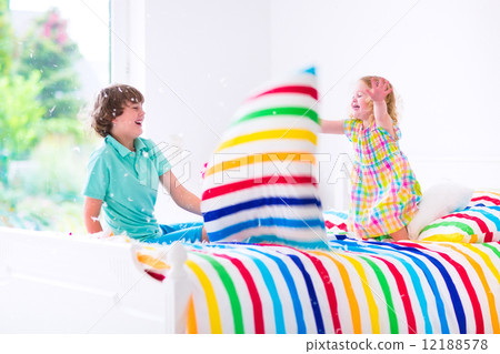 Kids having pillow fight 12188578