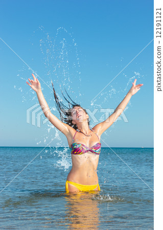 Beauty Model Girl Splashing Water in the ocean 12191121