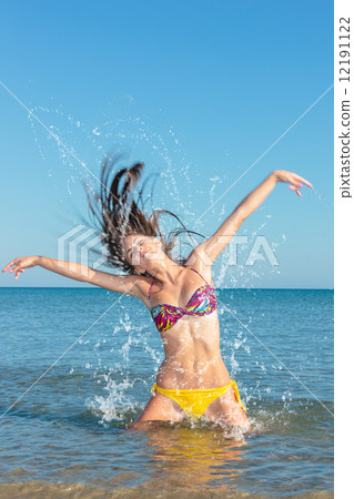 Beauty Model Girl Splashing Water in the ocean 12191122