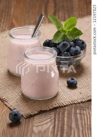 yogurt with blueberries in a glass jar and blueberries in a glas yogurt with blueberries in a glass jar and blueberries in a glas 12197825