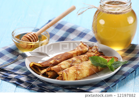 pancakes with honey on a plate, the honey in a glass bowl pancakes with honey on a plate, the honey in a glass bowl 12197882