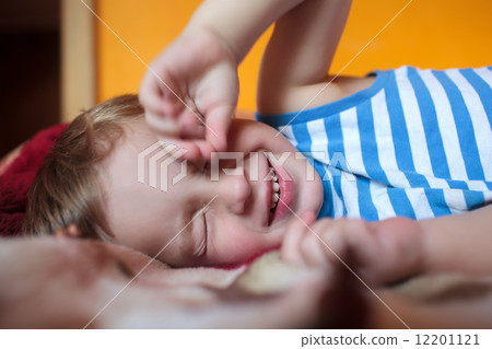 Little sleepy boy on the bed 12201121