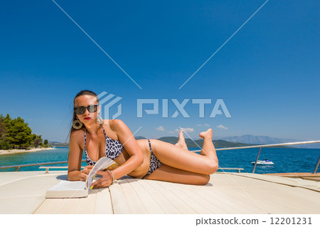 Young woman on her private yacht Young woman on her private yacht 12201231
