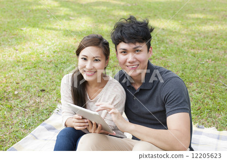 Young couple sharing a tablet. 12205623
