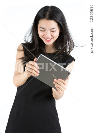 Asian lady playing a game on tablet 12205653