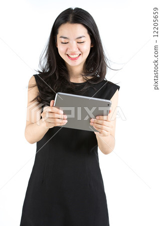 Asian lady playing a game on tablet 12205659