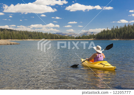 Woman Kayaking on Beautiful Mountain Lake. 12205777