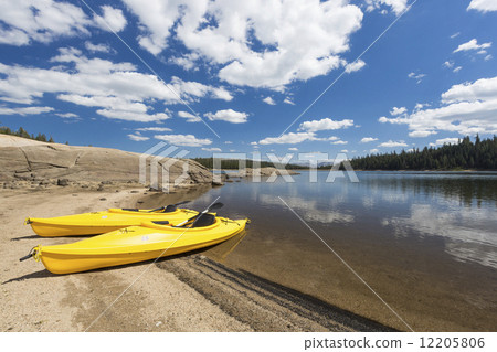 Pair of Yellow Kayaks on Beautiful Mountain Lake Shore. 12205806