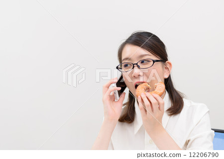A woman who calls while eating a donut A woman who calls while eating a donut 12206790