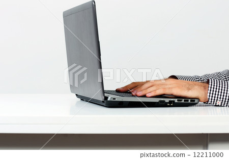 Side view image of a male hands using on the laptop 12211000