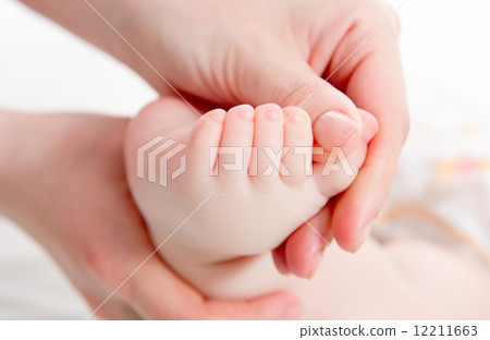 Mother massaging her baby Mother massaging her baby 12211663