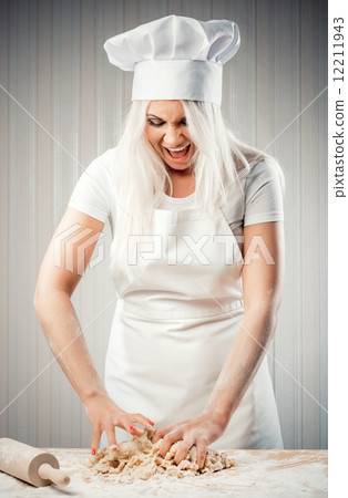 Angry and stressed out woman cook kneading dough Angry and stressed out woman cook kneading dough 12211943