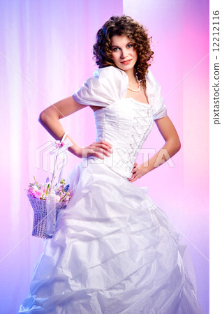 Beautiful bride with a basket of spring flowers indoors Beautiful bride with a basket of spring flowers indoors 12212116