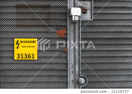 Grey fence with yellow warning sign Grey fence with yellow warning sign 12216727