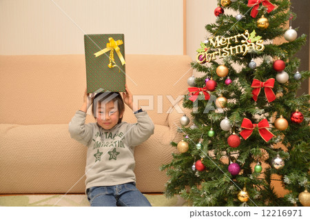 Boy with a Christmas present 12216971