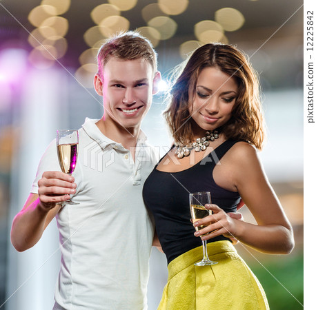 Young attractive couple with glasses of sparkling champagne 12225842