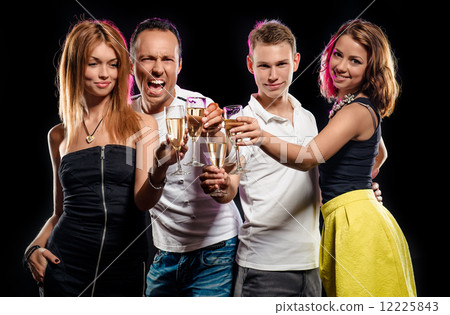 Cheerful group of young people with glasses of sparkling champagne 12225843