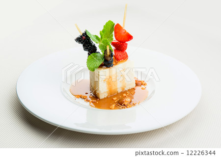 Delicious cheesecake and fresh berries on white plate Delicious cheesecake and fresh berries on white plate 12226344