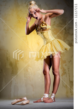 Beautiful ballerina in yellow tutu indoors Beautiful ballerina in yellow tutu indoors 12227211