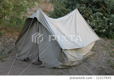A old USSR tent on a picnic in a forest on a sand with grass A old USSR tent on a picnic in a forest on a sand with grass 12227693