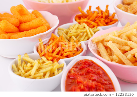Potato, corn and wheat chips in bowls Potato, corn and wheat chips in bowls 12228130