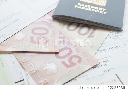 Canada passport with boarding pass on the table Canada passport with boarding pass on the table 12228686