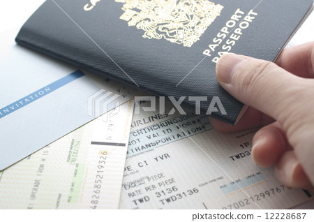 Holding Canada passport with boarding pass Holding Canada passport with boarding pass 12228687