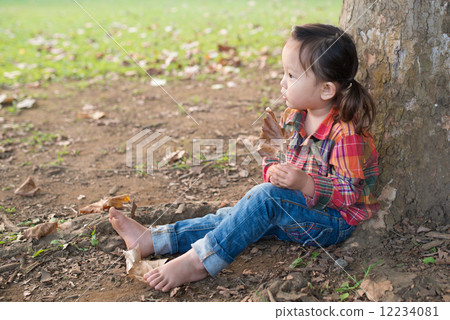 A girl leaning on a tree A girl leaning on a tree 12234081