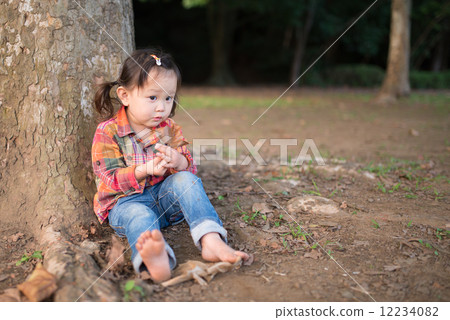 A girl leaning on a tree 12234082