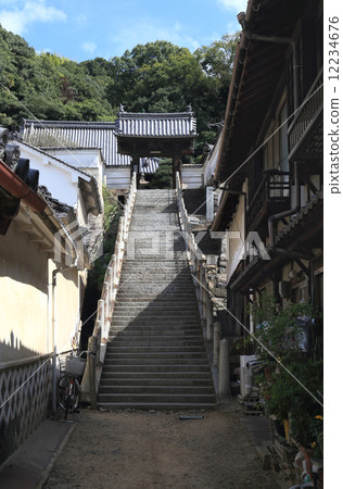 Takehara City, a stone stairway heading for Higashi-ji Temple from Honmachi in the preserved town area Takehara City, a stone stairway heading for Higashi-ji Temple from Honmachi in the preserved town area 12234676