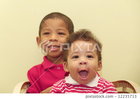 Portrait of two african brothers.  Focus in the front kid. 12235713