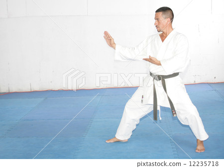 Black belt Man in kimono during training karate kata exercises 12235718