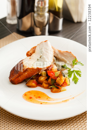 stuffed pork tenderloin roulade garnished with vegetables stuffed pork tenderloin roulade garnished with vegetables 12238394