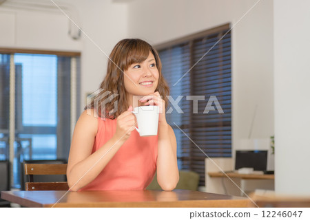 A woman relaxing at the dining room 12246047