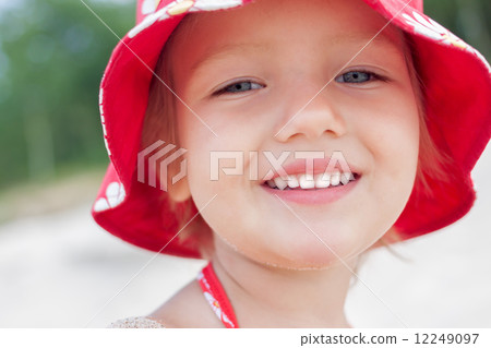 cheerful child girl smiling face close up outdoor 12249097