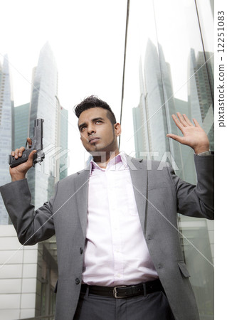 Businessman holding gun outdoors Businessman holding gun outdoors 12251083