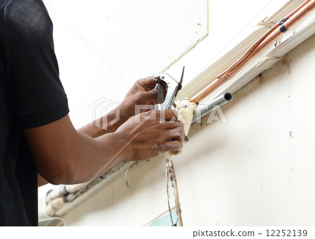 cutting a copper pipe with a pipe cutter 12252139