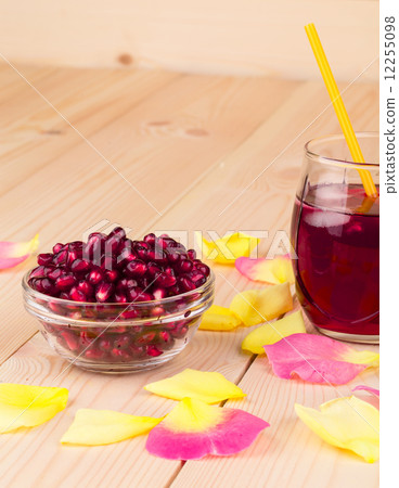 Opened pomegranate seeds and juice. 12255098